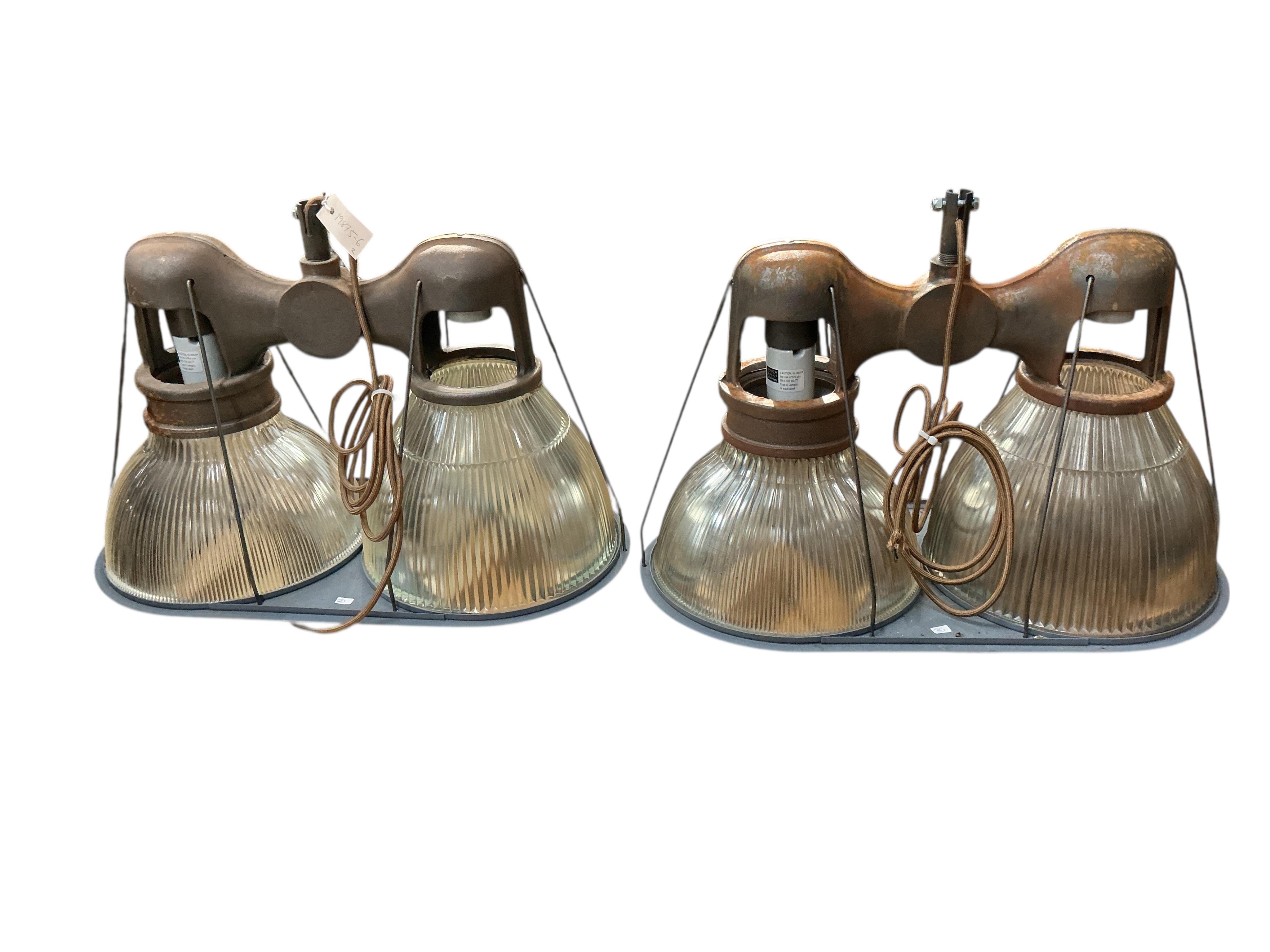 A pair of Holophane double industrial factory lights, width 64cm, height 42cm